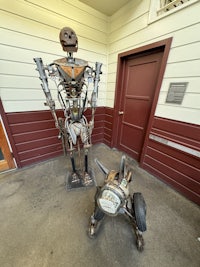 a statue of a robot standing in front of a door