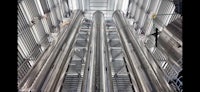 the inside of a large metal building with many pipes