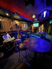 a woman sitting at a table in a bar