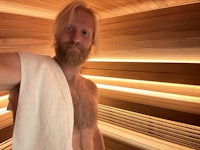 a man doing a handstand in a sauna