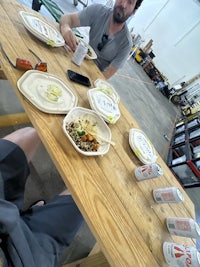 a group of people sitting at a table eating food