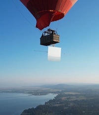 a hot air balloon with a white board attached to it