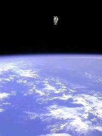 a man is floating in space above the earth