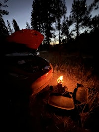 a campfire in the middle of a field at night