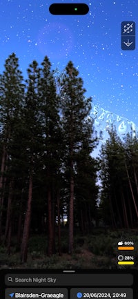 an image of a night sky with trees in the background